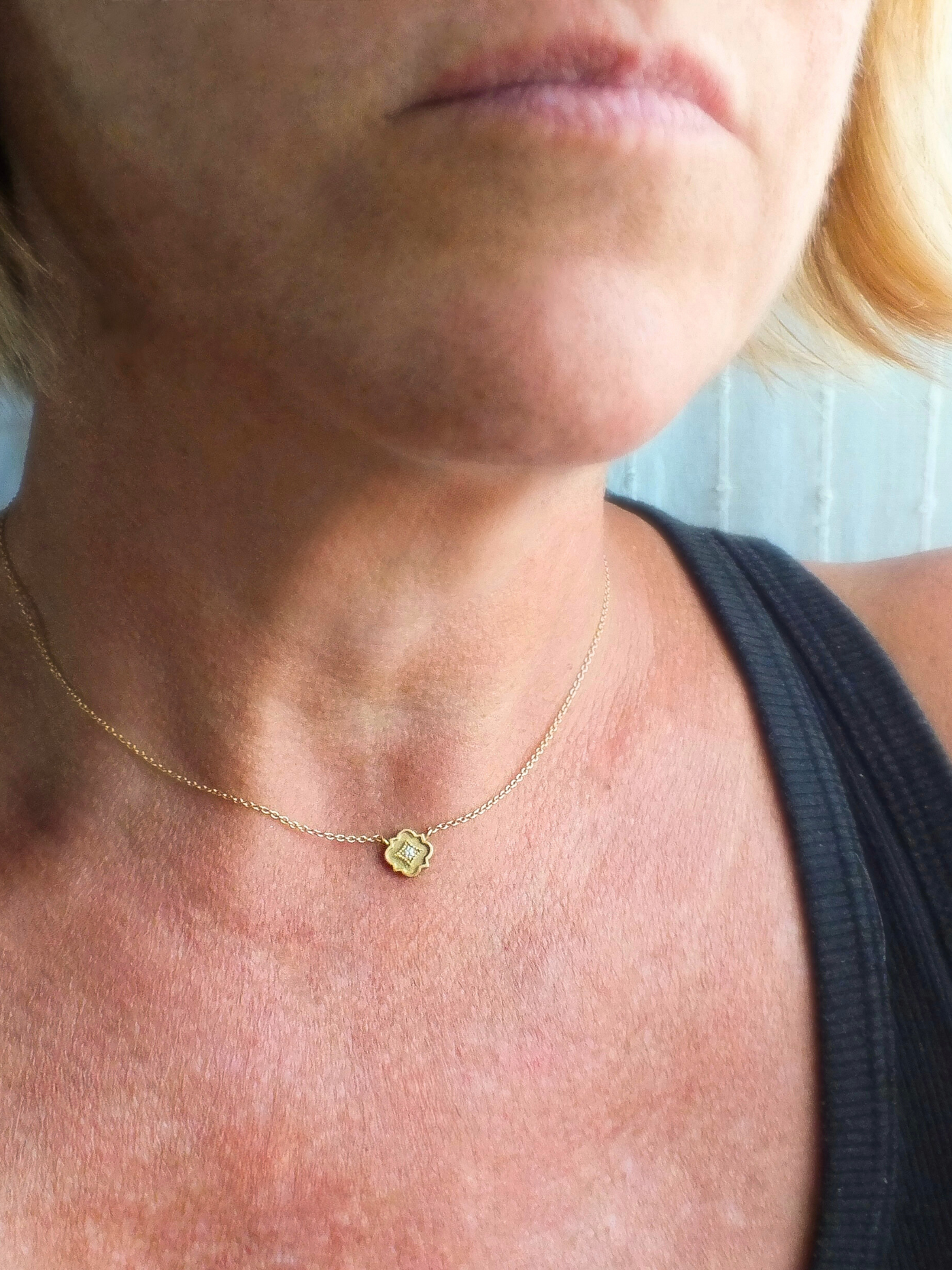 delicate 18k gold station necklace featuring a tiny quatrefoil pendant set with a sparkling diamond in a millgrain-bordered frame. Inspired by Gothic architecture and sacred geometry, this necklace is a modern talisman of light, protection, and inner radiance.