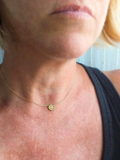 delicate 18k gold station necklace featuring a tiny quatrefoil pendant set with a sparkling diamond in a millgrain-bordered frame. Inspired by Gothic architecture and sacred geometry, this necklace is a modern talisman of light, protection, and inner radiance.