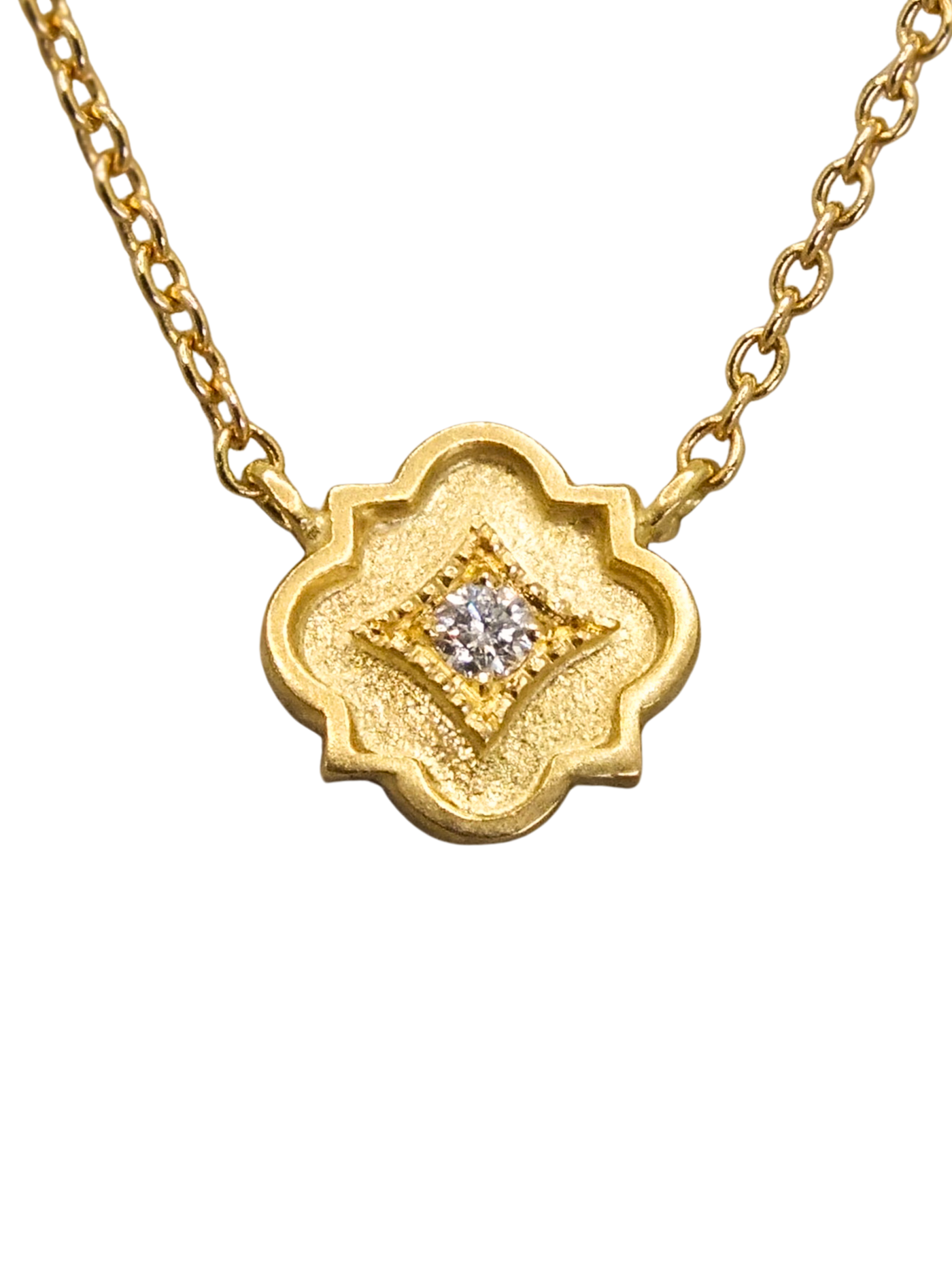 delicate 18k gold station necklace featuring a tiny quatrefoil pendant set with a sparkling diamond in a millgrain-bordered frame. Inspired by Gothic architecture and sacred geometry, this necklace is a modern talisman of light, protection, and inner radiance.
