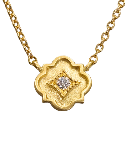 delicate 18k gold station necklace featuring a tiny quatrefoil pendant set with a sparkling diamond in a millgrain-bordered frame. Inspired by Gothic architecture and sacred geometry, this necklace is a modern talisman of light, protection, and inner radiance.