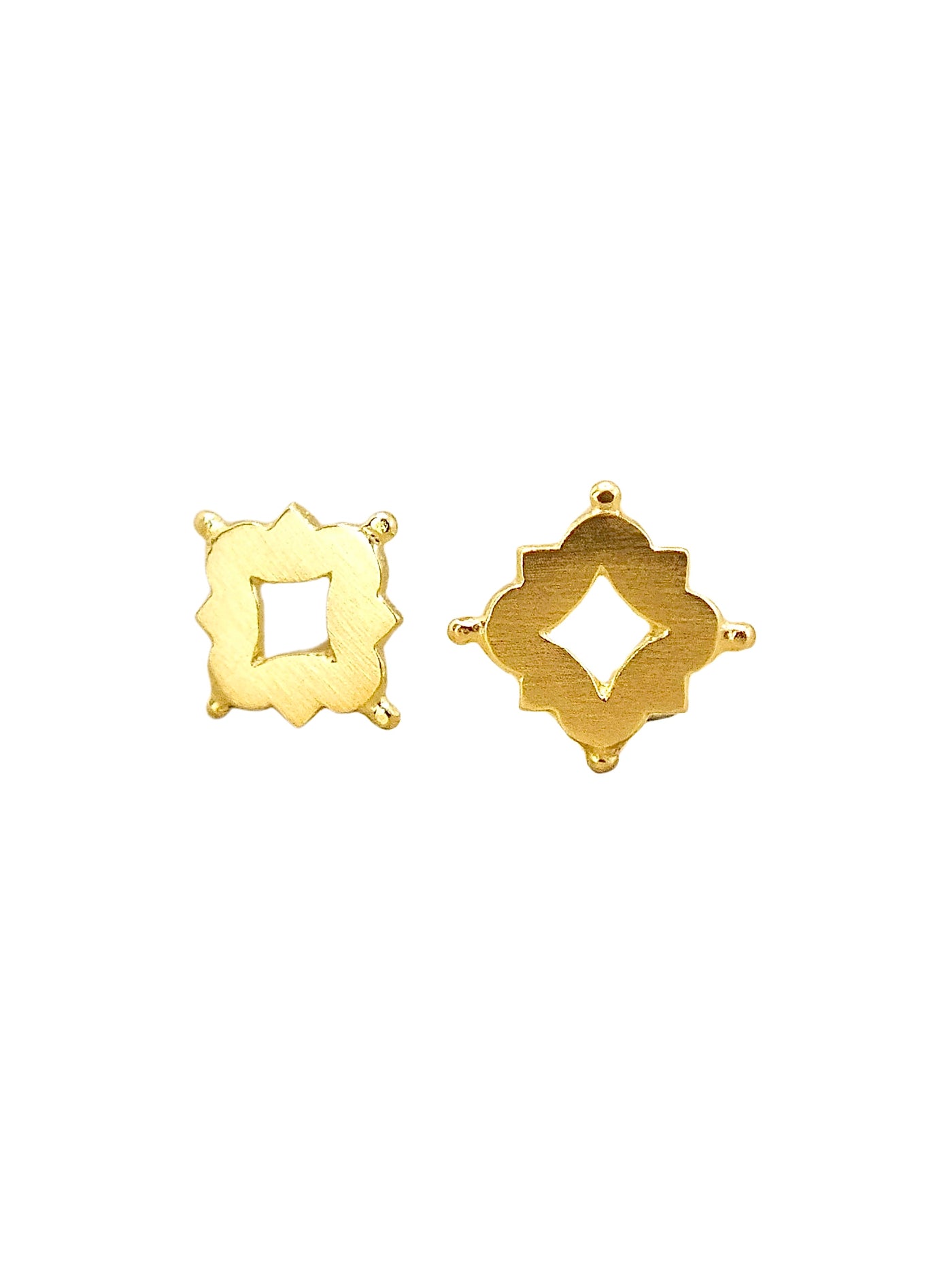 Pair of solid 18k gold stud earrings featuring a quatrefoil-inspired design with a central diamond-shaped cutout, accented by small granule-like details at each corner. The openwork creates a delicate window of light at the center, echoing the intricate tracery of Medieval and Renaissance architecture. A blend of historical elegance and minimalist form, perfect for everyday wear or timeless adornment
